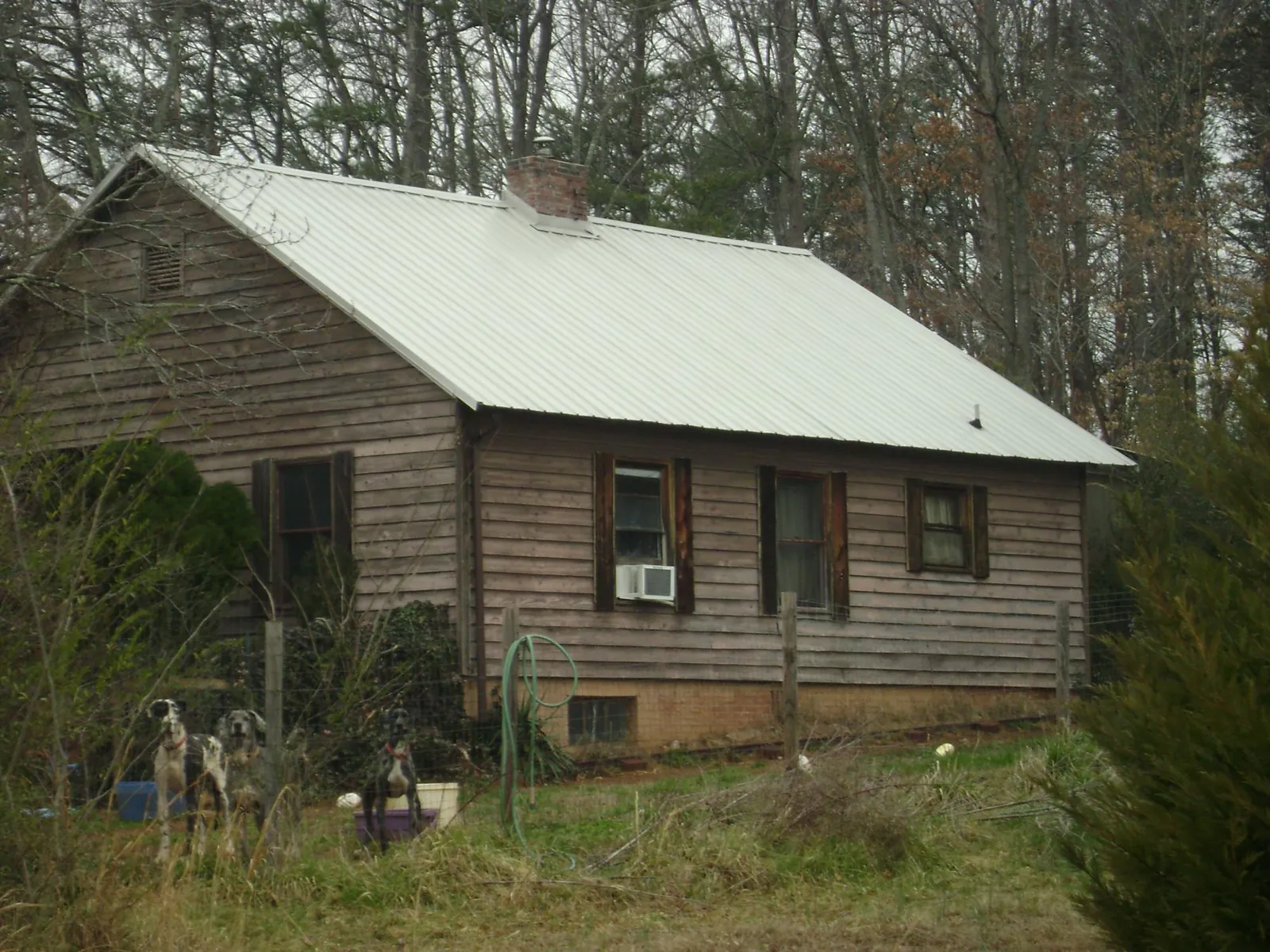White metal roof on an old wood sided farmhouse, from a Metal Roof Installation job in High Shoals